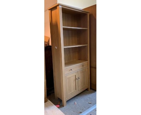 A contemporary light oak open bookcase, with two adjustable shelves over drawer and cupboard, H185cm W85cm, D36cm