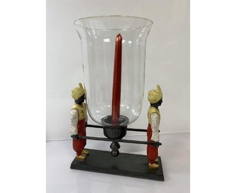 A cast painted metal candle centrepiece with candlestick and glass shade carried by two litter-bearers (36cm x 25cm x 18cm)