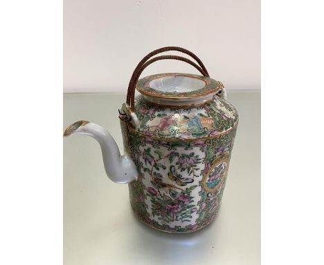 An early 20thc Chinese Canton famille rose teapot complete with circular top and scrolling spout and twin cord mounted handle