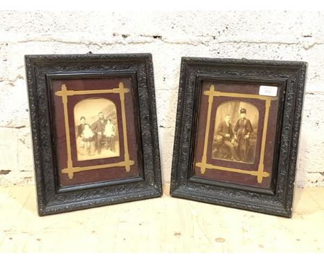 A pair of late 19th century family portrait photographs, in ebonised floral composition moulded frames, one photograph printe