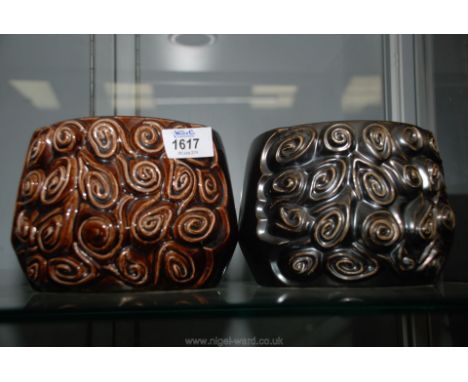 A pair of Sylvac plant pots with swirly 'button' design in relief.  One in chocolate brown with base label for 1970s and impr