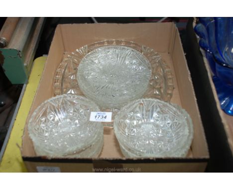 A glass dessert set of dishes, plates and platter.