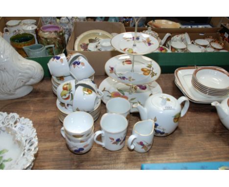 A Royal Worcester Evesham teaset comprising teapot, sugar basins, milk jugs, tea plates, cups, saucers and a cake stand. one 