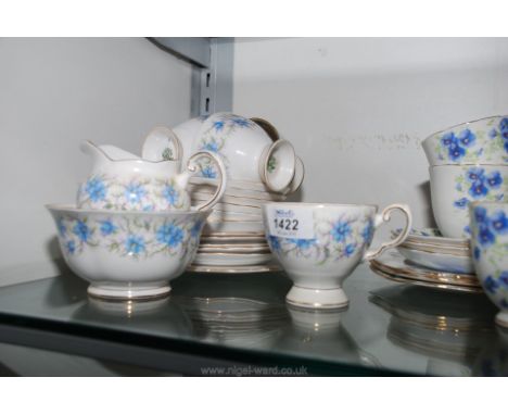 A Tuscan part tea set with blue flowers consisting of bread and butter plate, five tea plates, six saucers, five cups, sugar 