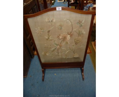 A Mahogany framed Firescreen with lightwood stringing, the panel needlework to portray stylised flowering plants and fruiting