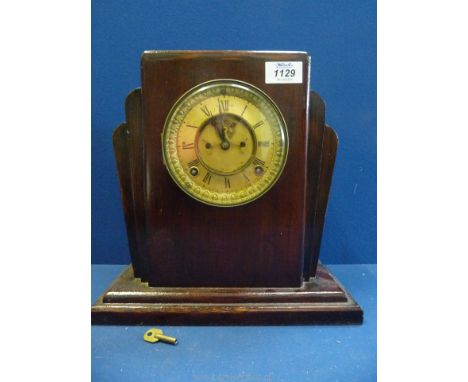 A Mantle Clock with key having Roman numerals, Art Deco style.