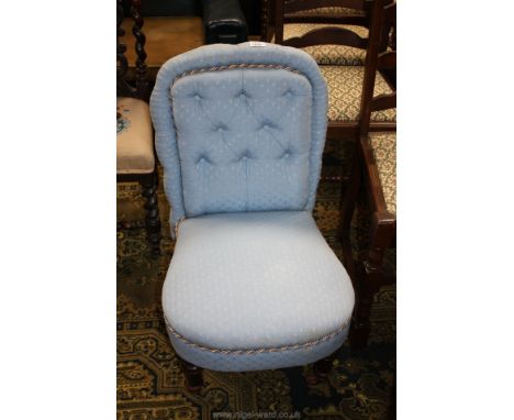 A pretty pale blue upholstered button back Edwardian Nursing Chair with turned front legs.
