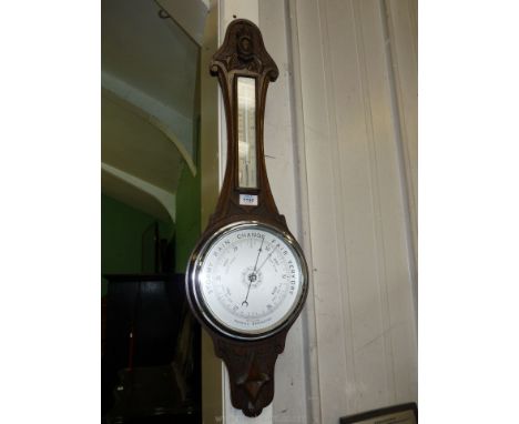 A large oak carved Banjo Barometer with mercury thermometer.