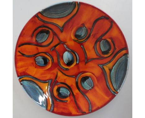 Large Poole pottery circular dish, decorated in the Peacock pattern on a burnt orange ground, (diameter 40cm) in original oct