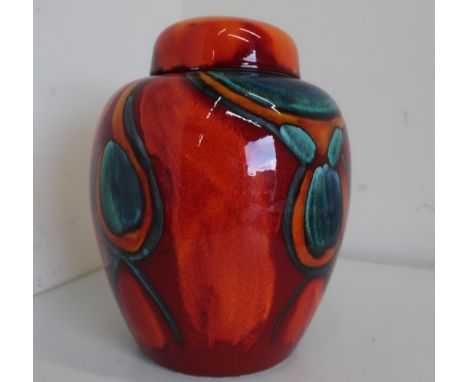 Large Poole pottery ginger jar and cover, decorated in the Peacock pattern, on burnt orange ground (H32cm) 