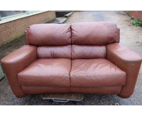 Large leather two seat sofa on raised circular wood supports (width 230cm) and a matching smaller two seat sofa (width 180cm)