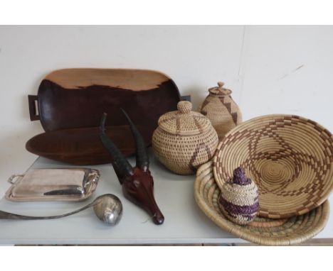 Two eastern carved hardwood rectangular trays, carved hardwood model of a impala head, two woven dishes and two similar baske