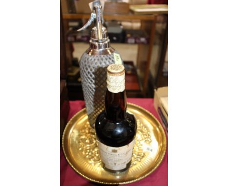 		A bottle of Hage Gold Label Liquer Scotch whiskey, chromium plated soda syphon and a brass embossed tray. C.R. All good. Wh