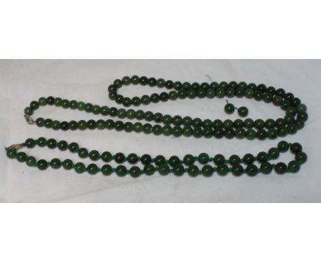 		Two Chinese jade bead necklaces together with a pair of matching ear studs. 19th Century. C.R. All good