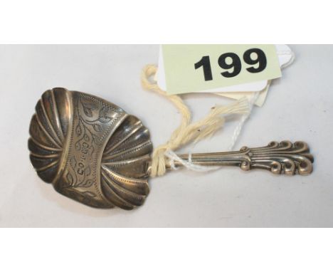 		A silver caddy spoon with fluted bowl. London 1844. C.R. All good