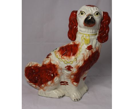 		A Staffordshire spaniel painted in iron red with yellow collar and chain, 19th Century, 12' high. C.R. Minor losses to pain