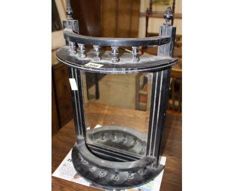 		An Edwardian ebonised hanging wall shelf with beveled plate