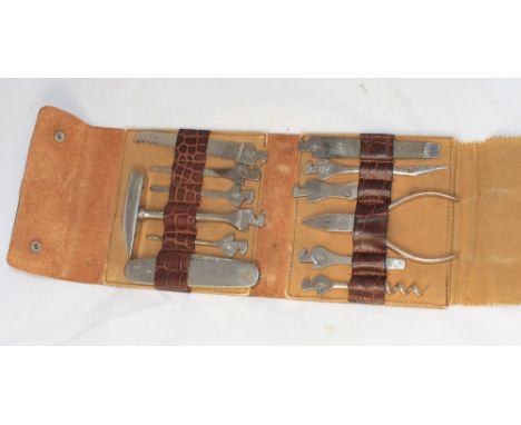 		A leather cased fitted with a variety of small tools to include hammer, pliers, folding knife etc. C.R. Generally good