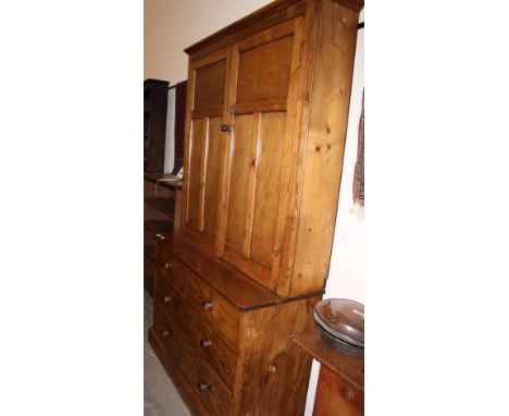 		A pine dresser enclosed by a pair of panel doors over base with two short over two long drawers on plinth support. 45' wide