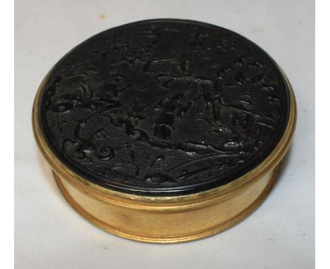 		A French pressed tortishell and gilt metal snuff box in oriental taste. Late 18th or early 19th Century. 2 1/2' diam. C.R. 