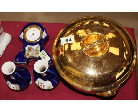 		A porcelain clock garniture together with a Royal Worcester casserole dish. C.R. All good