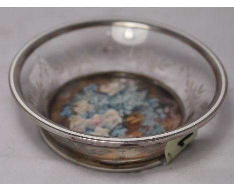 		A glass and silver mounted trinket bowl with wheel cut decoration of garlanded rose flowers. The base with inset watercolou