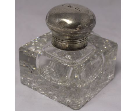 		A hobnail cut glass inkwell with silver collar and domed, hinged lid. London 1903. Initials F K G to the lid. 4' high. C.R.