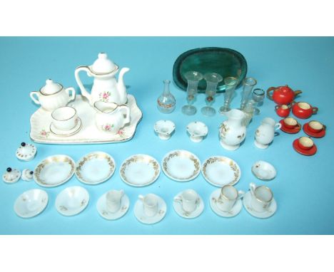 A collection of doll's house china and glass, including five wine glasses, two carafes, white glass jugs, cups, saucers and p