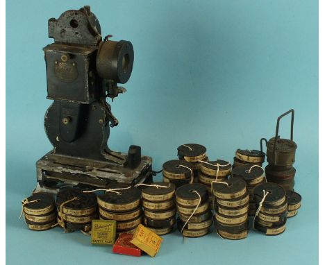 A Pathescope PB-Ex projector with 58 film reels, including Charlie Chalpin films "The Isle of Surprises", "Rolling Around", "