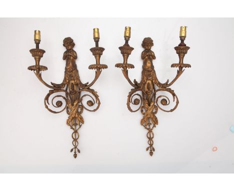 A Pair of Gilt Brass Twin Branch Wall Lights, 19th century, surmounted by a pan pipe palying cherub with two sconces above dr