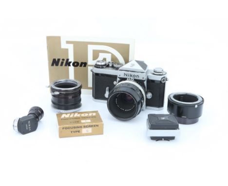 A Nikon F SLR Camera, chrome, serial no. 6993710, with Micro-Nikkor f/3.5 55mm lens, body, F, mirror sticking up, slow speeds