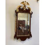 An early 19th century Chippendale design mahogany and parcel gilt fret carved pier glass, having
