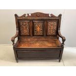 A late Victorian oak box seat settle, width 107cm, depth 44cm, height 109cm. Condition - fair