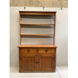A Victorian pine dresser with open rack, width 137cm, depth 47cm, height 216cm. Condition - fair
