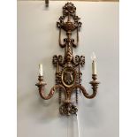 A pair of Louis XV style carved giltwood twin branch wall lights, height 110cm. Condition - fair