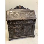 A late 19th century Flemish carved oak bureau, width 100cm, depth 49cm, height 133cm. Condition -