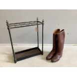 An early 20th century tubular brass and cast iron twelve division stick stand, width 50cm, height