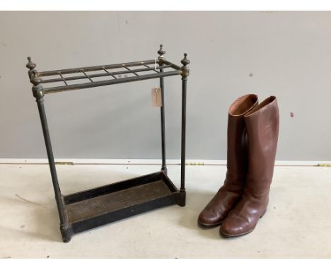An early 20th century tubular brass and cast iron twelve division stick stand, width 50cm, height 61cm together with a pair o
