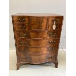 A reproduction George III style mahogany serpentine chest of nine drawers, width 76cm, depth 51cm,