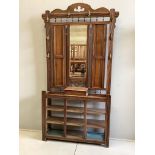 A late Victorian oak hallstand with cast brass elephant head hooks, width 115cm, height 210cm.