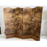 An Edwardian four fold draught screen, covered with a Brussels machine made woodland scene, each