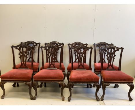A set of eight Victorian mahogany Chippendale style dining chairs having carved and pierced splats, stuff-over seats on acant