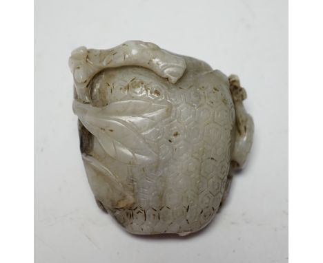 A Chinese carved white and black jade fruit shaped snuff bottle, 6cm high