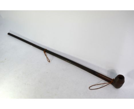 A Nigerian carved wood large tobacco pipe, 96 cm long