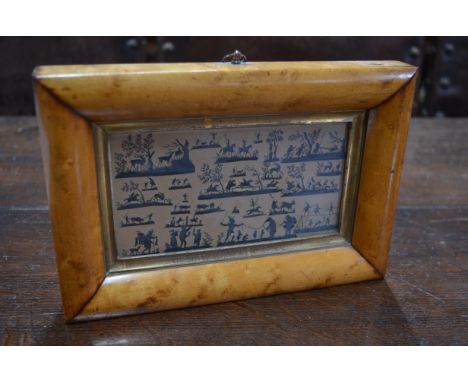 A framed collection of minute cut-out silhouette groups in the manner of Karl Frohlich (1821-98), depicting hunting and other