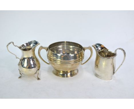 A heavy quality silver sugar basin, James Dixon &amp; Son, Sheffield 1944, to/w two Edwardian cream jugs in the Georgian styl