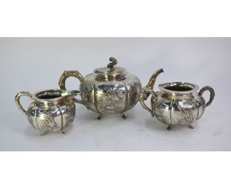 An elegant Chinese Export white metal tea service, comprising: an oviform teapot with hinged cover by Wang Hing &amp; Co. dec