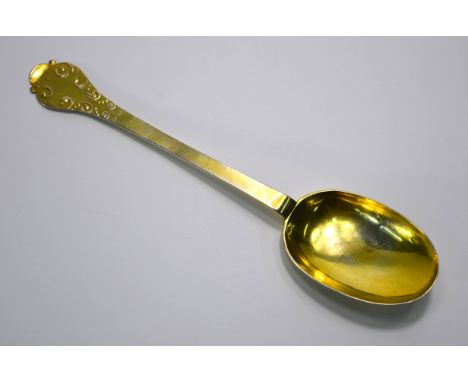 A William III West Country silver gilt modified trefid spoon with raised rat-tail and embossed foliage to back of bowl and fi