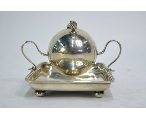 An Edwardian silver table cigarette lighter modelled as a mine raised on scrolling whiplash supports and tray base, with touc