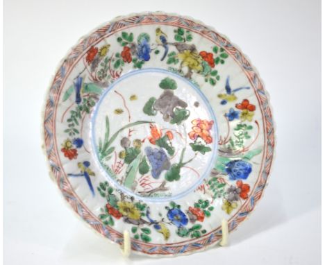 A small famille verte saucer dish, decorated in blue, green, orange, aubergine, yellow and underglaze blue with a design of b